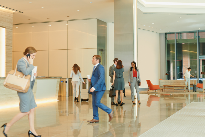 Image of business people doing their thing in a lobby of an office building