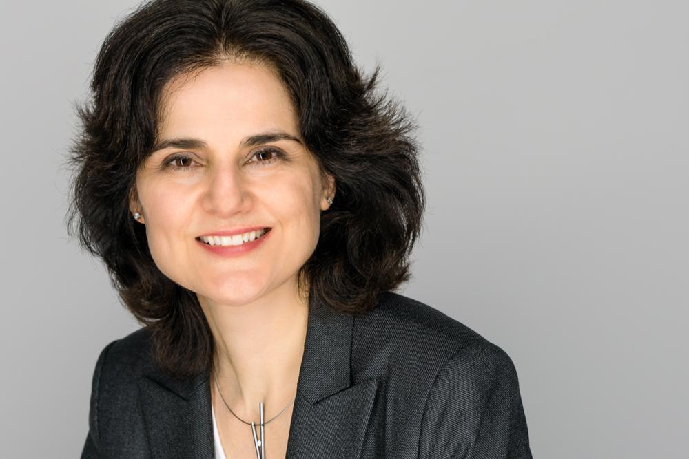 Professional headshot of Lia Chiarotto with grey background